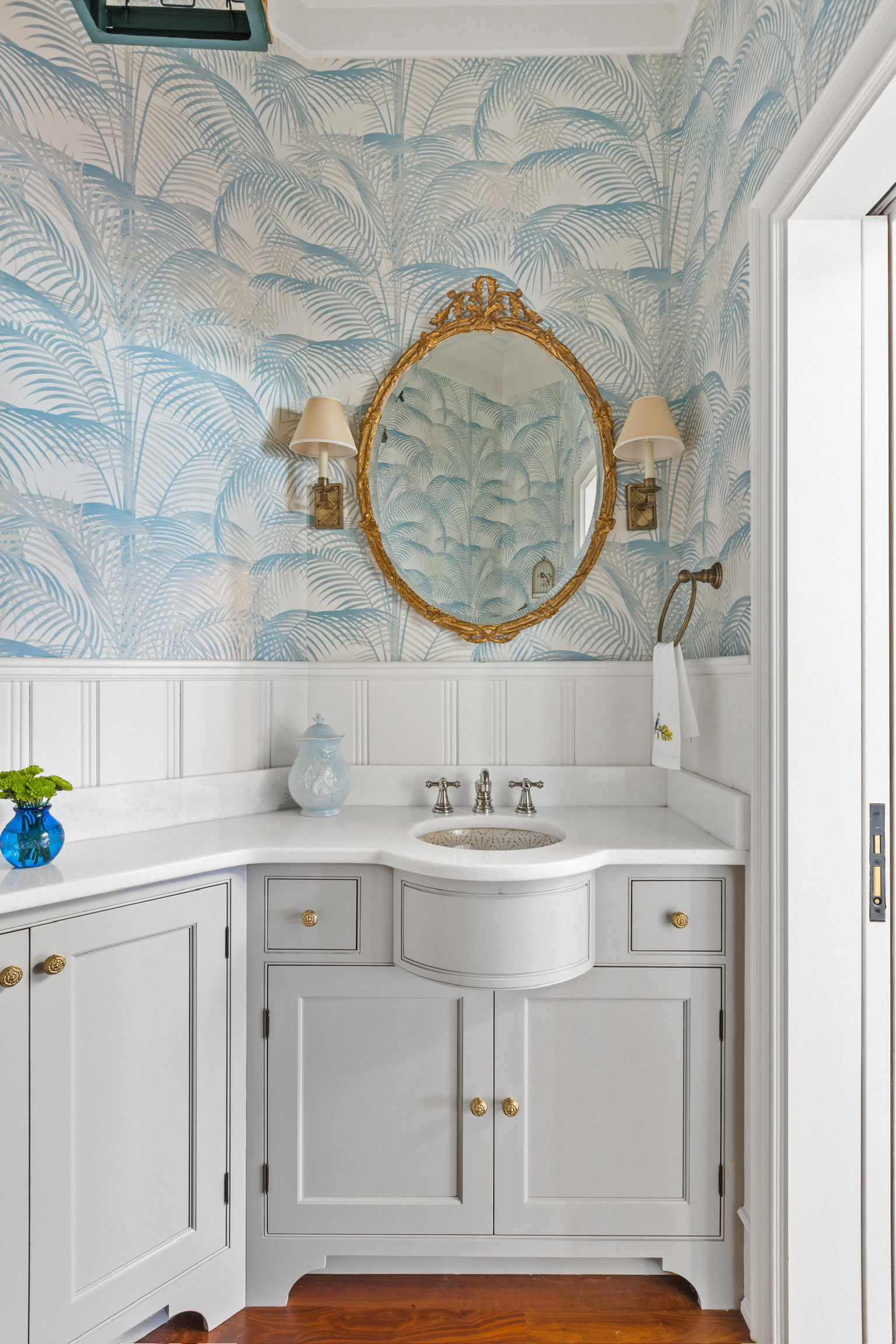 Bathroom with soft blue scenic wallpaper